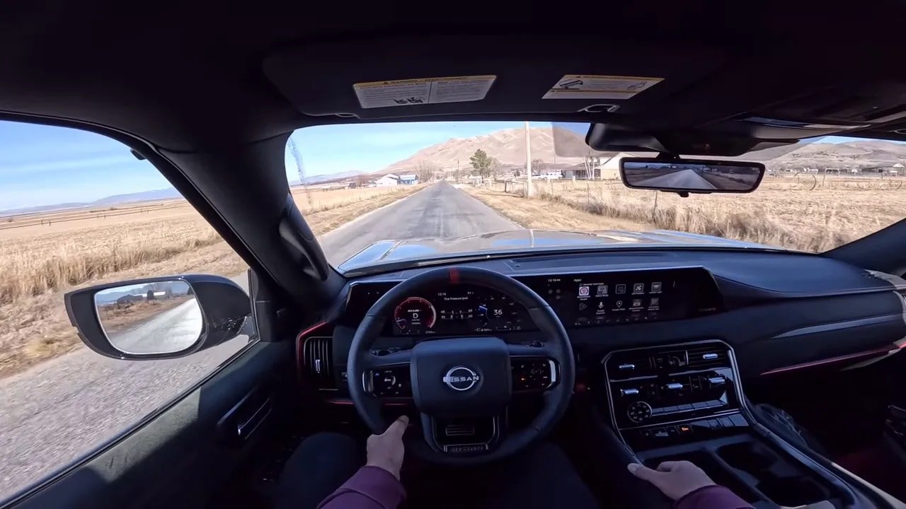 Clear driver point-of-view in the Nissan Armada Nismo showing steering wheel, instrument cluster and the road ahead