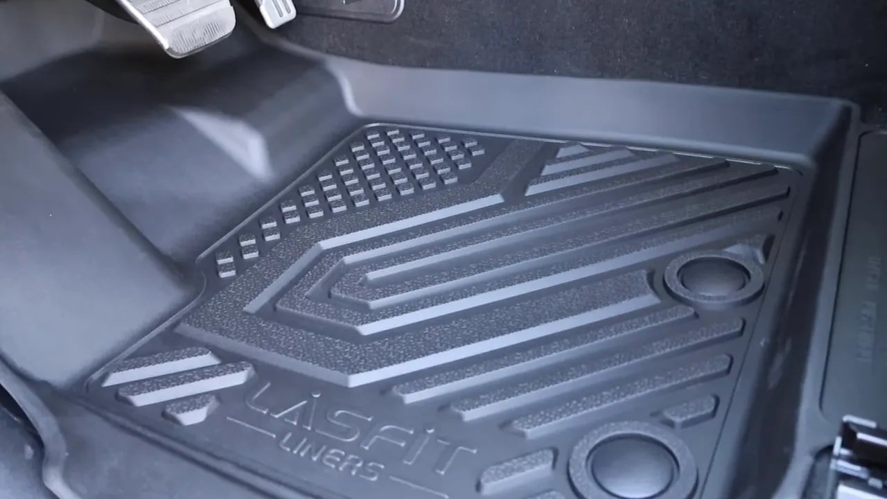 LASFIT TPE floor liner fitted in the Nissan Armada footwell showing pattern, raised lips and anchor holes
