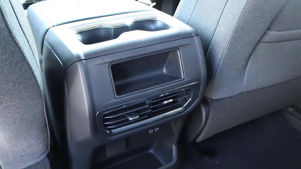 Rear center console and air vents with cubby storage and cupholders in Sierra EV rear cabin